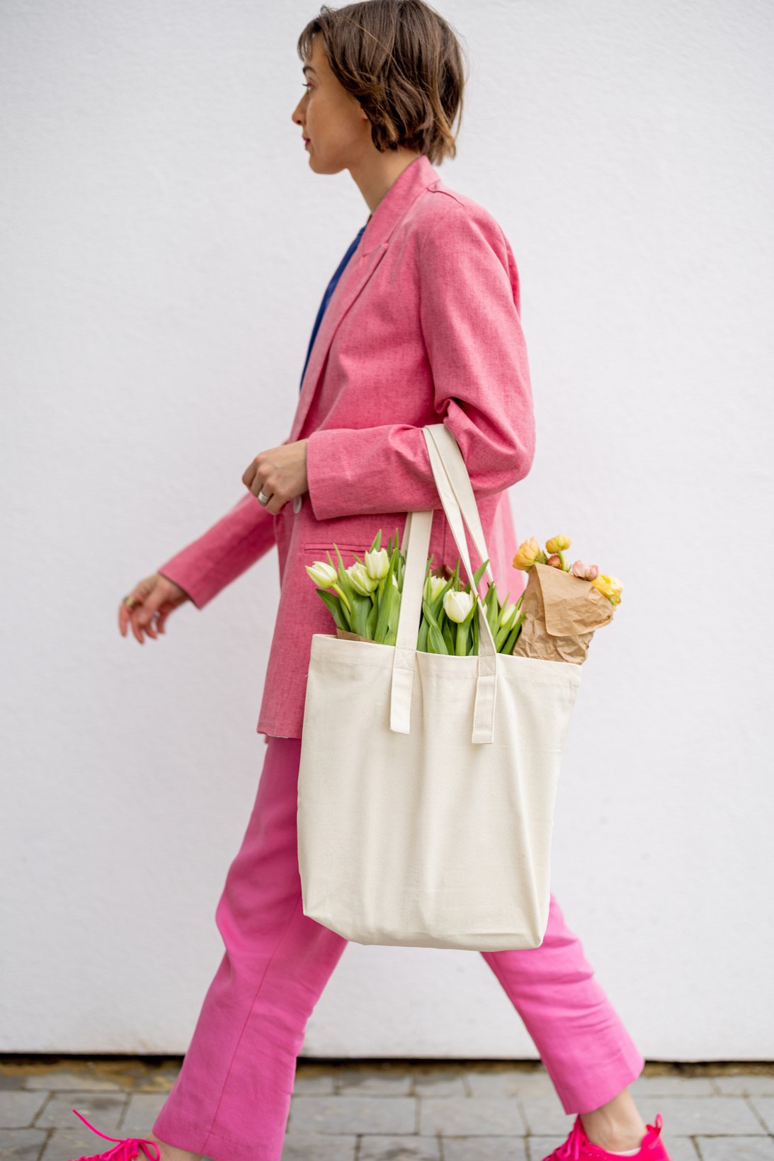 Stylish Woman Carrying Tote Bag with Flowers